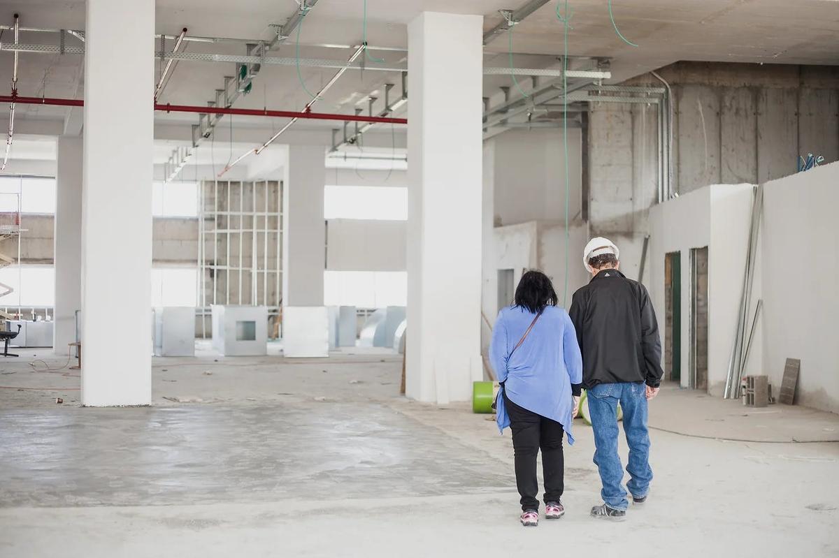 Two people walking at a construction site