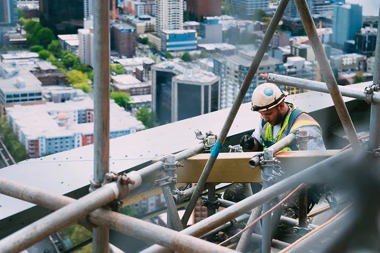 A worker at height on scaffolding