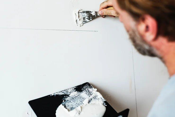 Worker applying plaster